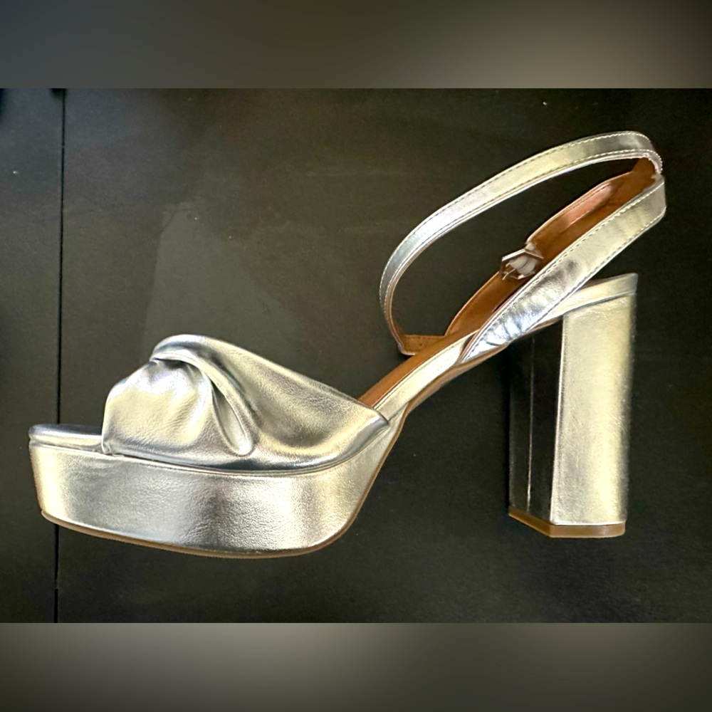 Silver platform heels. Brand new- size 10